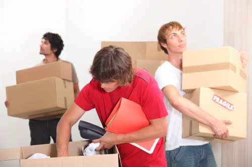 Careful loading of household furniture for transport in Highbury